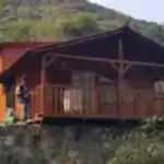 Arkası dağ yeşillikli kırmızı boya atılırken çekilen "müstakil ahşap karkaslı ev"