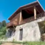 Gökyüzünün mavisi yeşil manzara içinde verandada oturup bişeyler içmek için tasarlanmış yapı